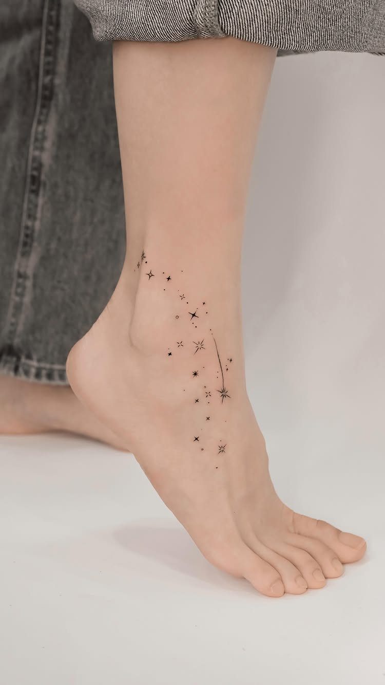 Small black star tattoos scattered across a person's ankle and foot.