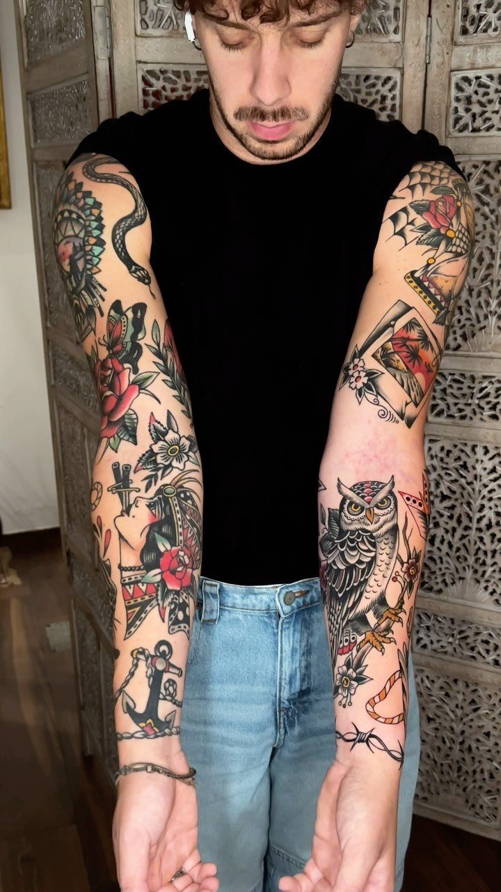 Man with colorful traditional style full sleeve tattoos on both arms.