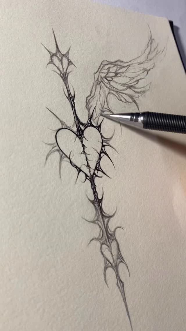 Heart with thorns and a wing drawn in black ink on paper.