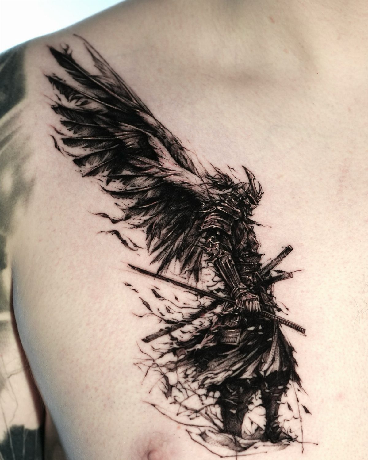 Winged warrior tattoo in black ink on a person's chest with detailed armor