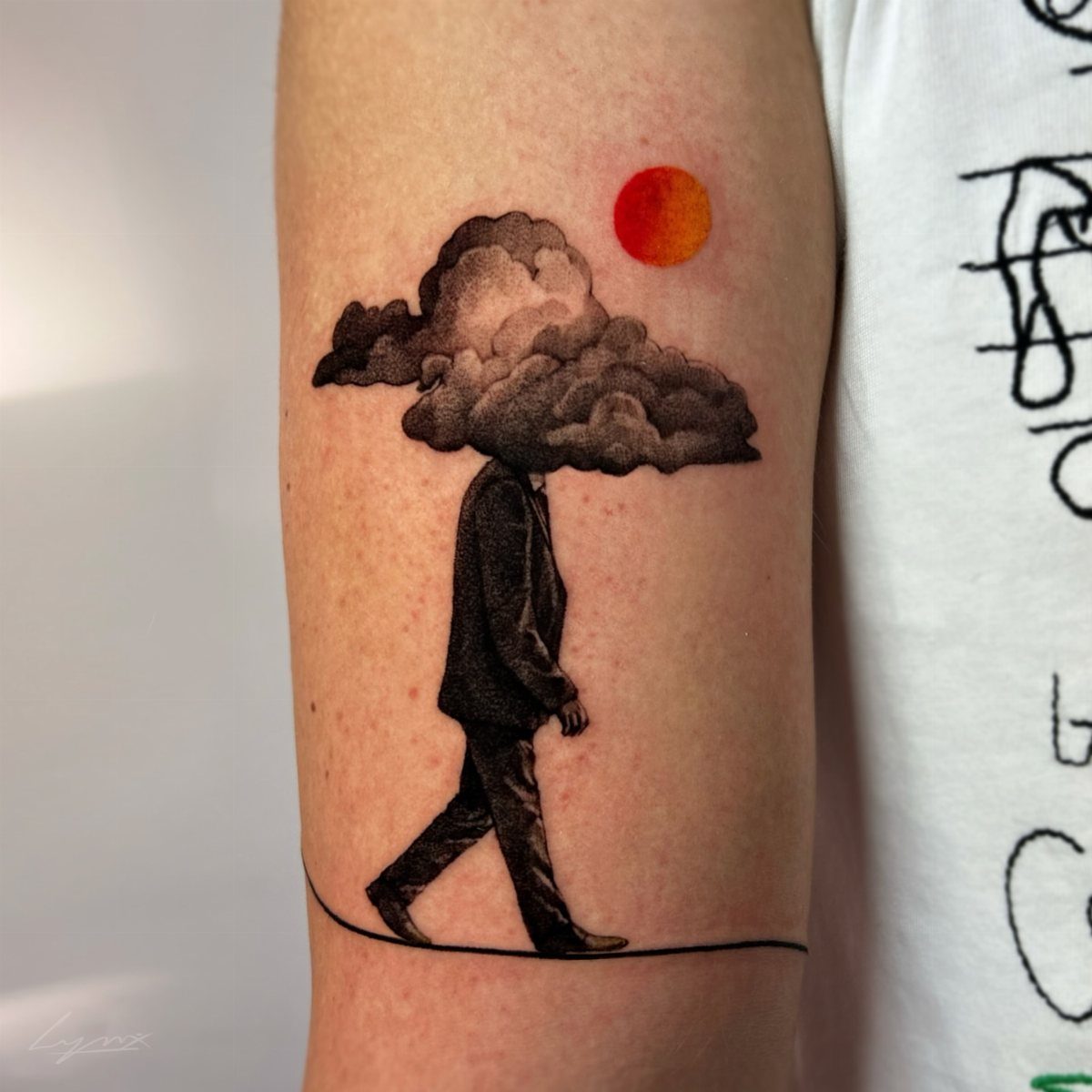 Tattoo of a man in a suit with a cloud for a head.
