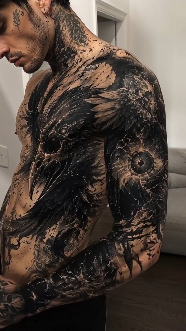 Man with detailed dark surrealist tattoos covering his neck, chest, and arm.