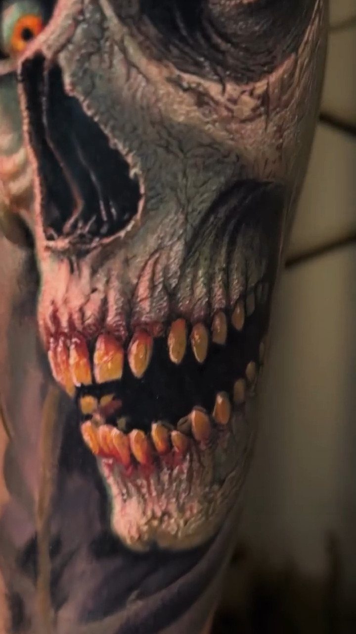 Detailed skull tattoo with yellowed teeth and realistic shading on human skin