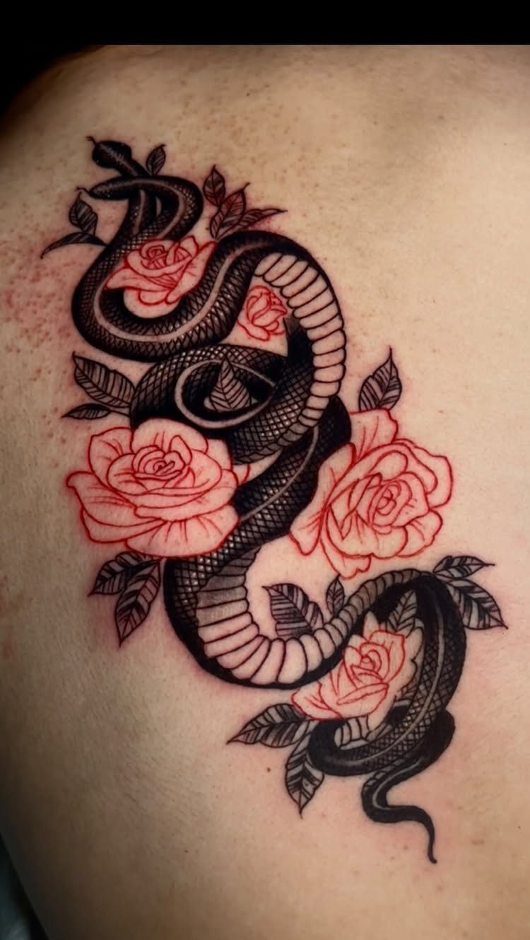 Black serpent tattoo entwined with red roses on a person's back.