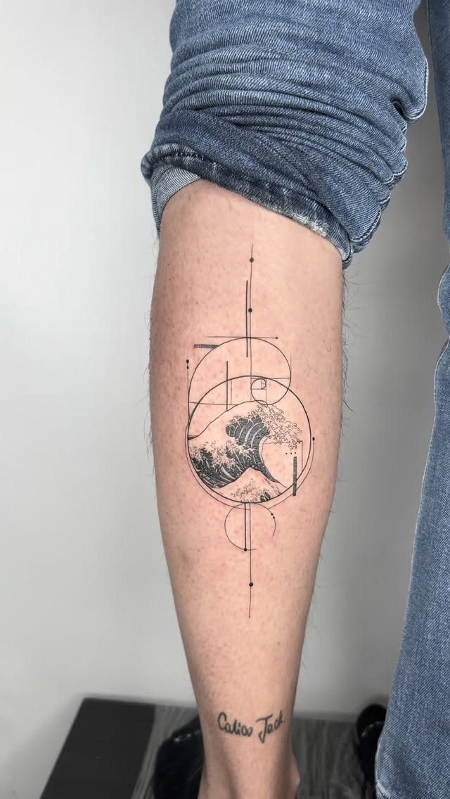 Geometric circle tattoo on a man's leg featuring a crashing ocean wave design.
