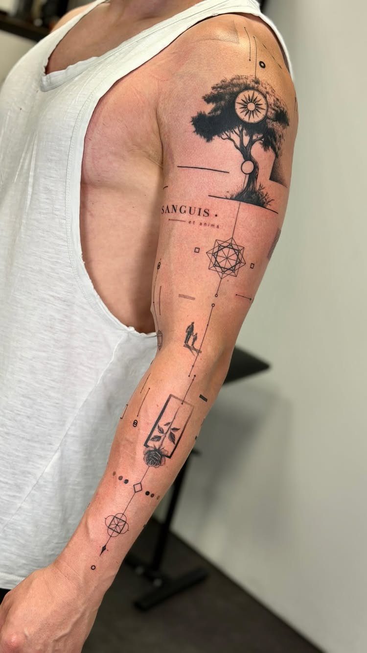 Man's arm with a detailed fine line black ink tattoo featuring geometric elements and a tree.