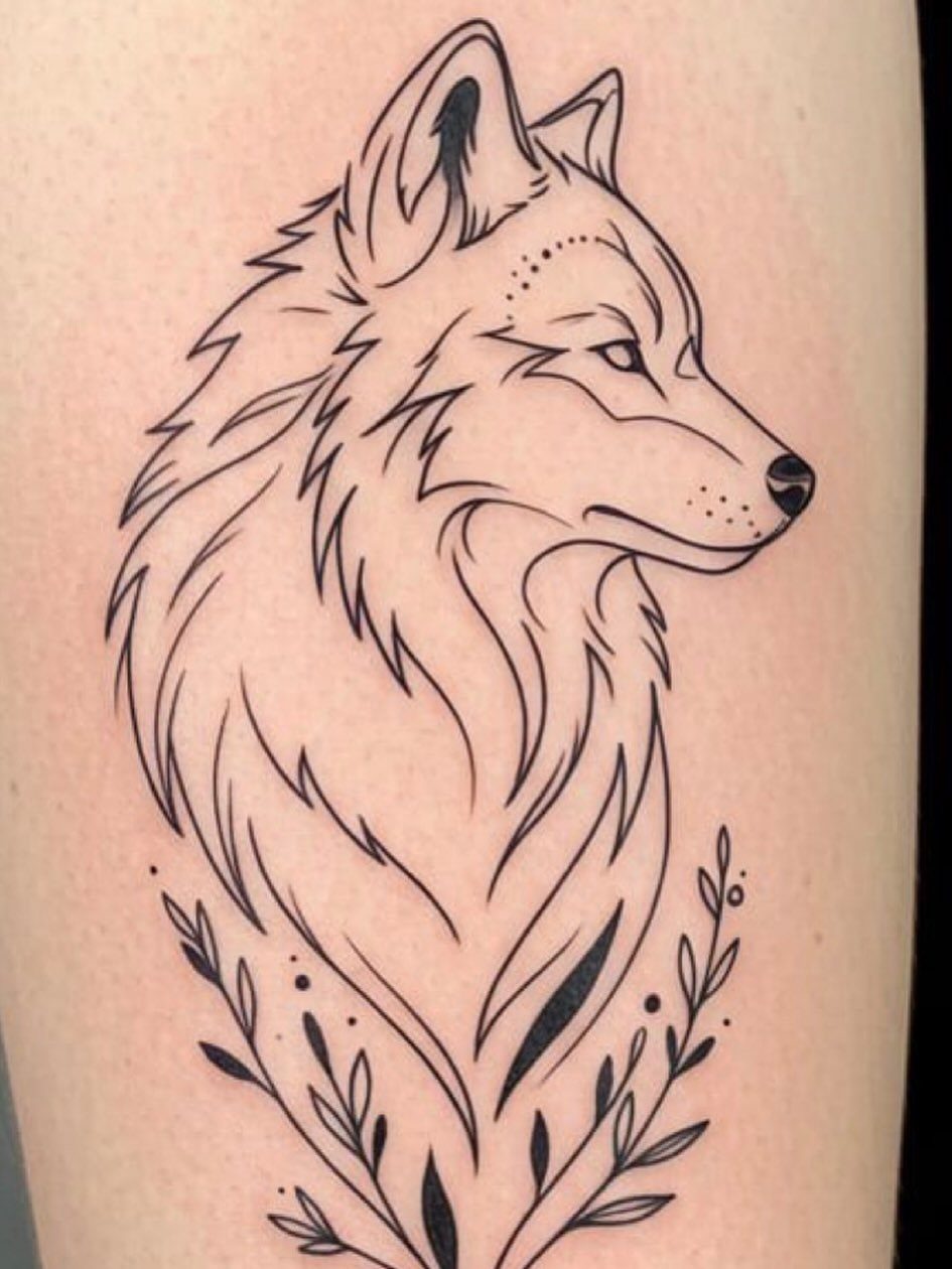 Fine line wolf portrait tattoo with botanical leaves on a person's skin.