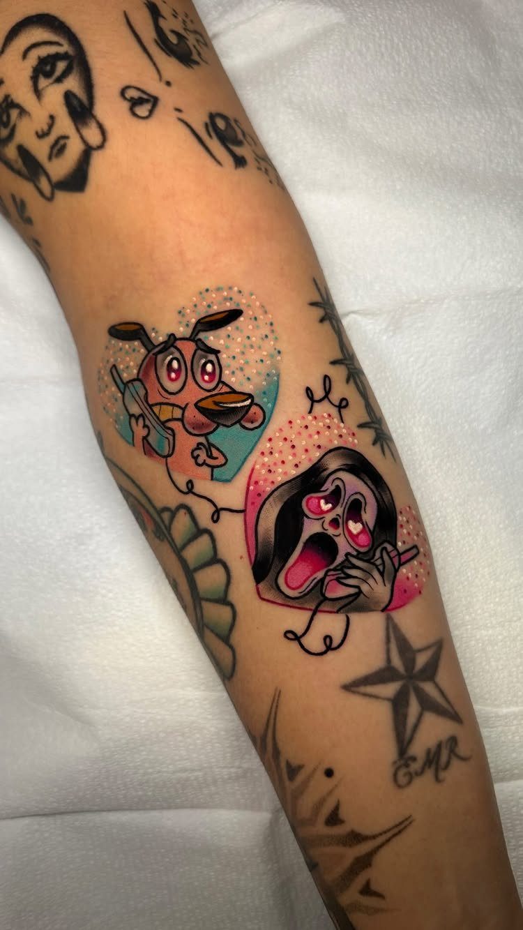 Colorful tattoos of Courage the Cowardly Dog and a screaming character on a forearm.