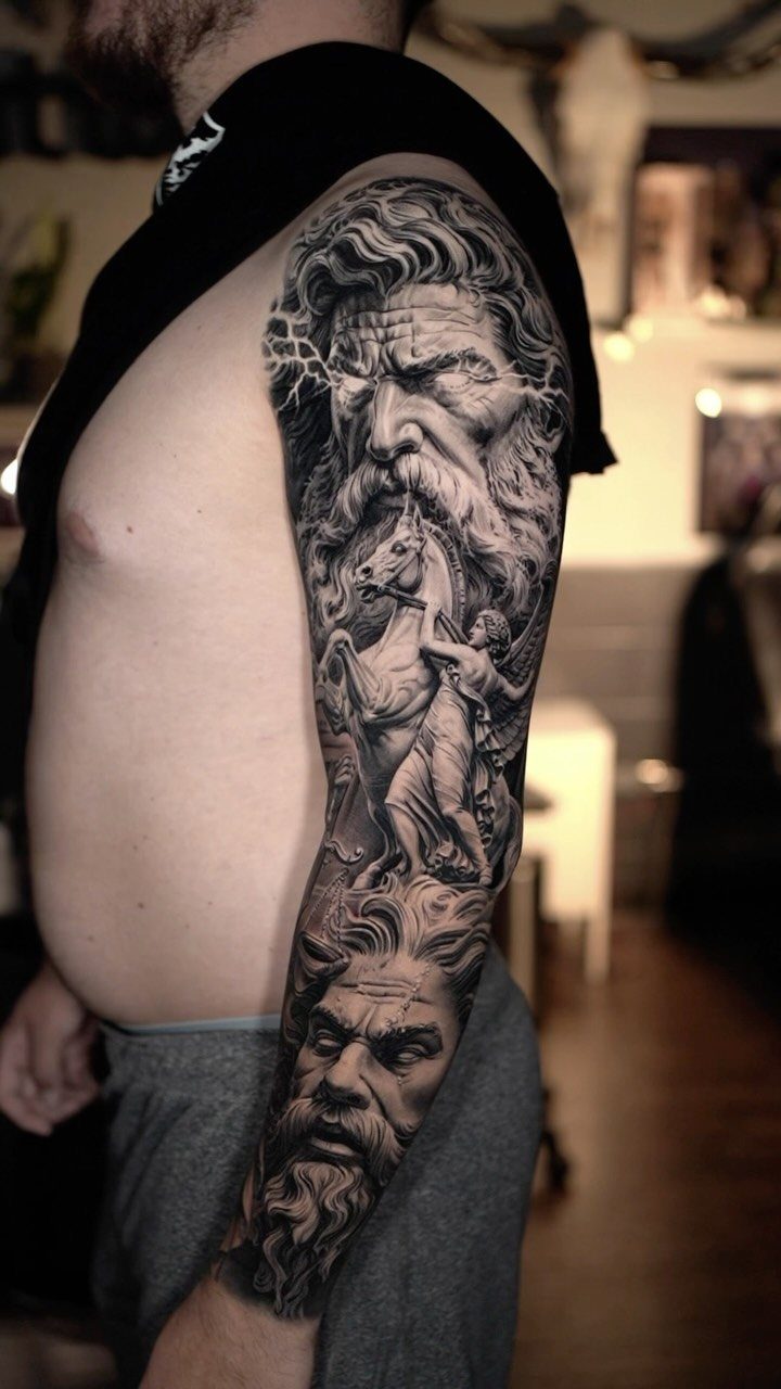 Full sleeve tattoo featuring mythological figures and a horse in black and grey realism.