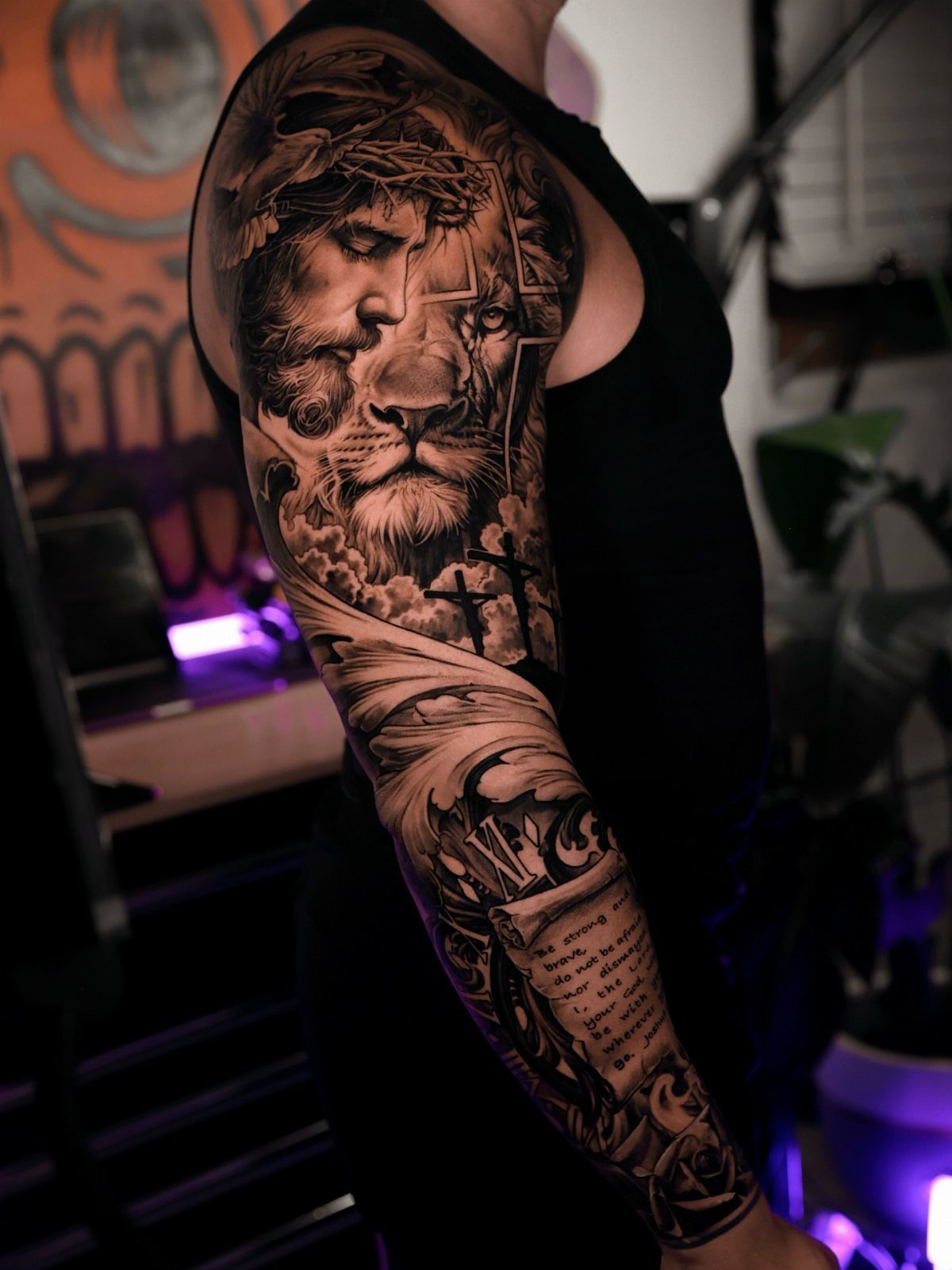 Full sleeve realism tattoo featuring a portrait of Jesus merged with a lion's face.