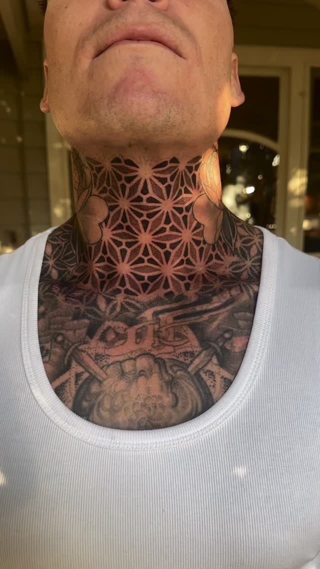 Geometric floral tattoo pattern covering a man's neck above a detailed chest piece.