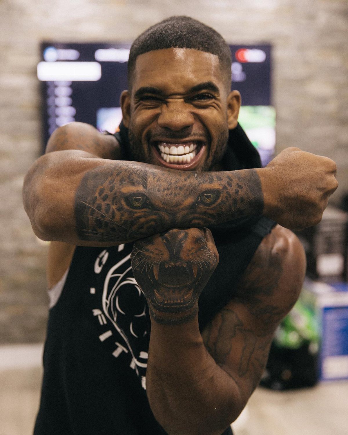 Man with a realistic leopard half sleeve tattoo on his muscular arm.