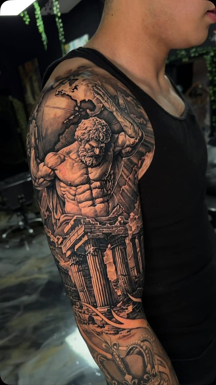 Half sleeve tattoo featuring a muscular bearded man and ancient Greek columns.