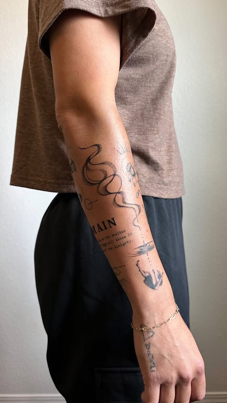 Man's forearm with a minimal patchwork half sleeve tattoo featuring various small black designs.