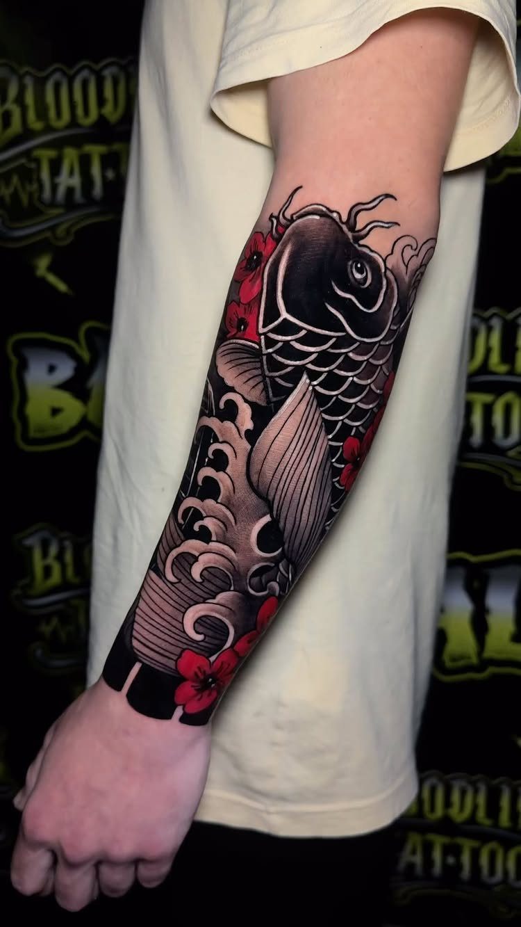 Forearm half-sleeve tattoo featuring a koi fish, waves, and red flowers.