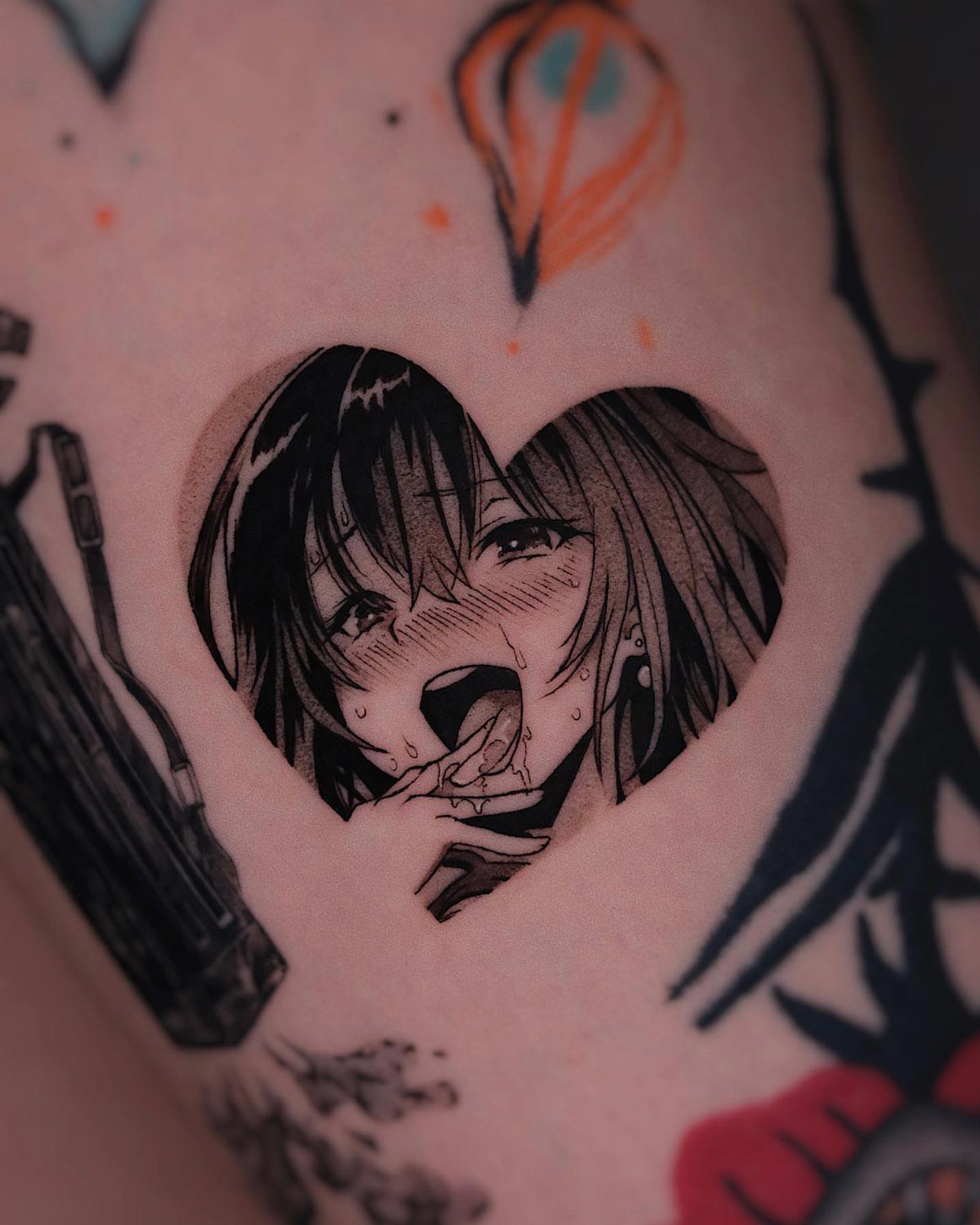 Anime woman's face framed inside a heart tattoo on a person's skin