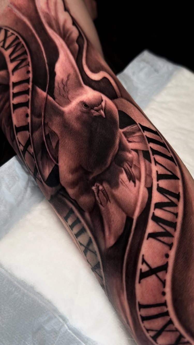 Dove tattoo with Roman numerals on a ribbon wrapped around a man's arm