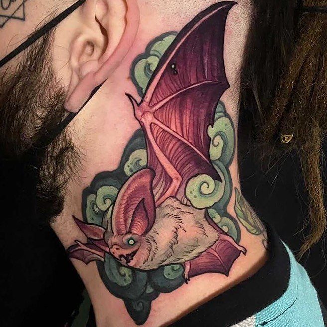 Bat tattoo on a person's side neck with purple wings and green clouds.