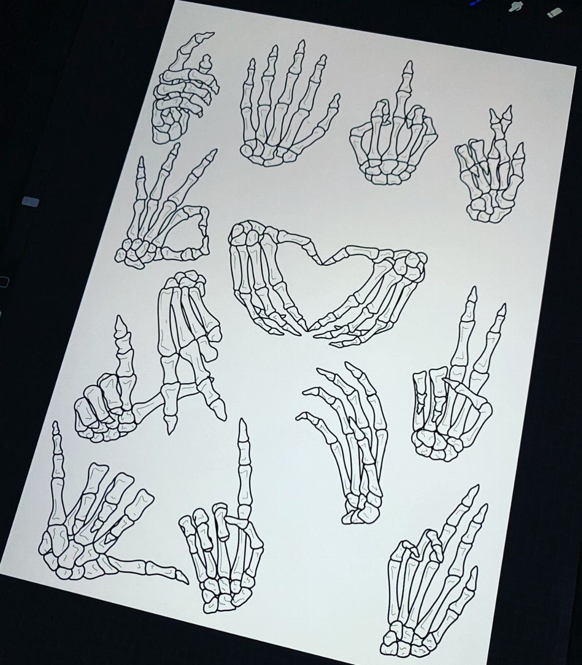 Multiple black ink line drawings of skeleton hands in various poses on white paper.