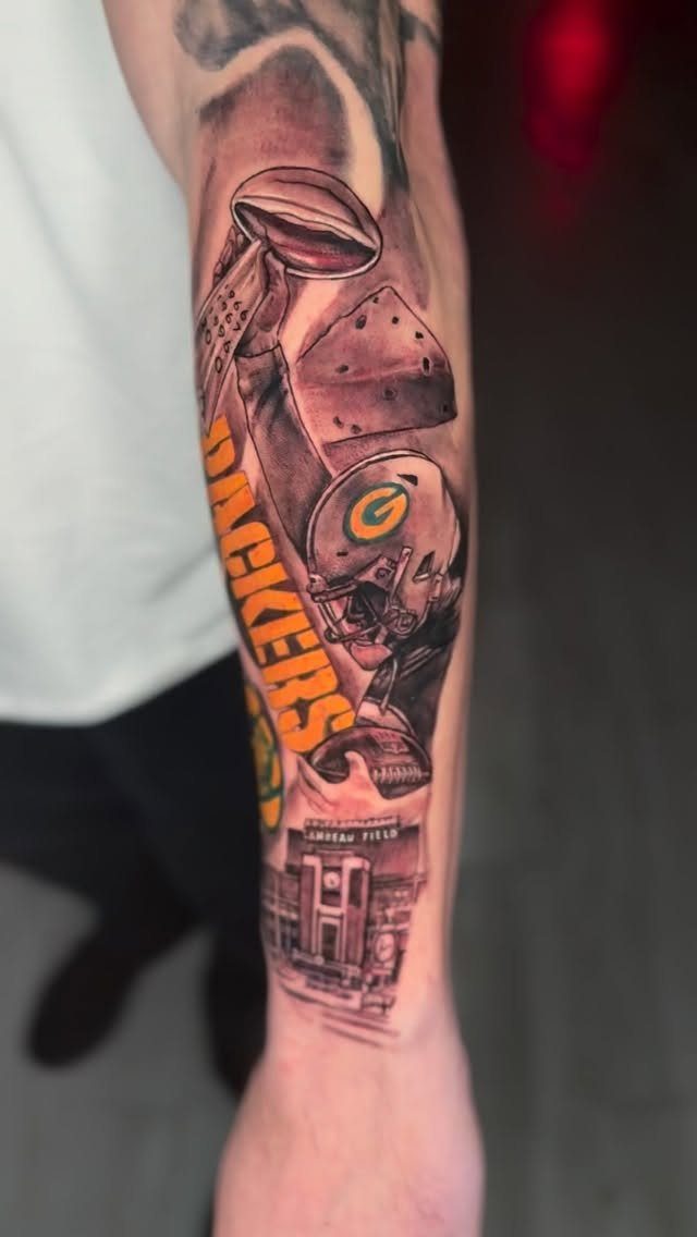 Sports tattoo on a forearm featuring Green Bay Packers helmet and team name.