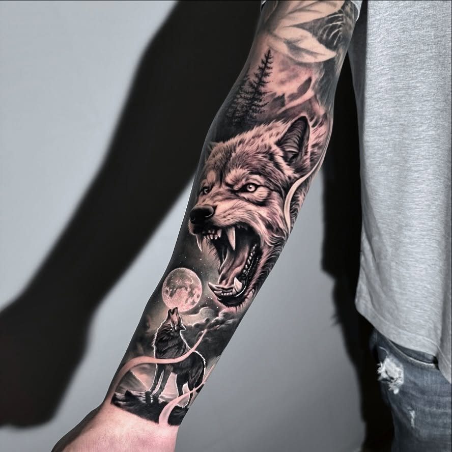 Wolf tattoo on a man's arm featuring a snarling wolf and a howling wolf.