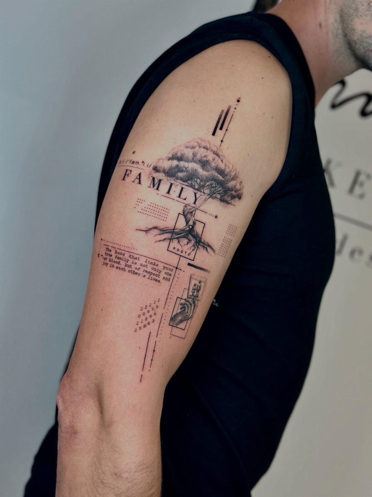 Family tree tattoo on a man's arm with text and a small portrait.