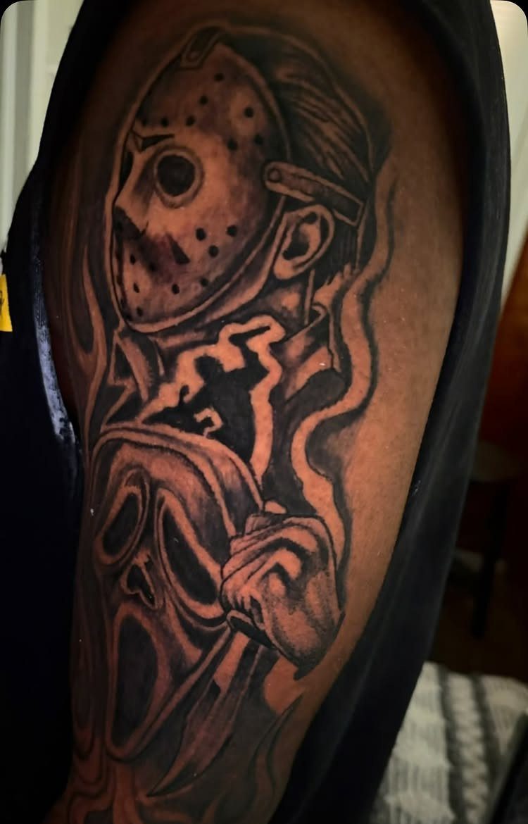 Horror movie character tattoo on an upper arm featuring Jason and Ghostface.
