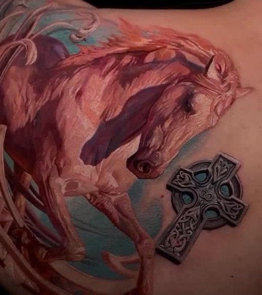 Horse and Celtic cross tattoo on a person's back in reddish and grey tones