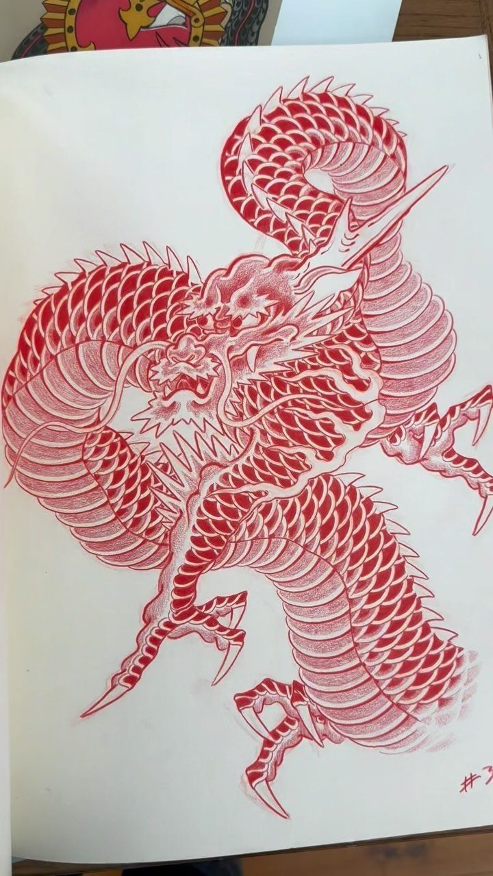 Red ink drawing of a Japanese dragon with detailed scales on white paper