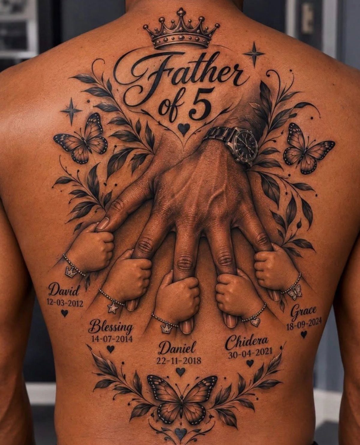 Detailed back tattoo of a father's hand holding five children's hands with names and dates.