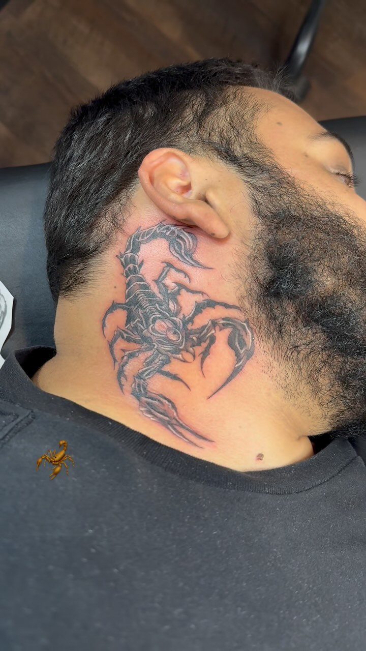 Scorpion tattoo on the side of a man's neck in black and grey ink.
