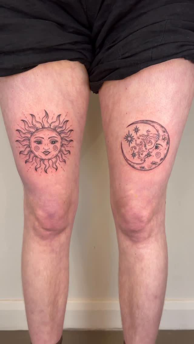 Sun and crescent moon tattoos with faces on a person's thighs.