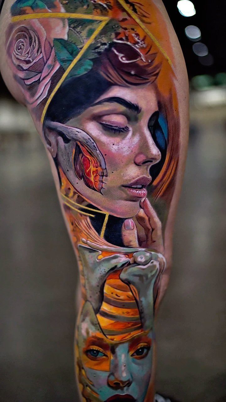 Full sleeve tattoo featuring realistic colorful female faces and roses on an arm.